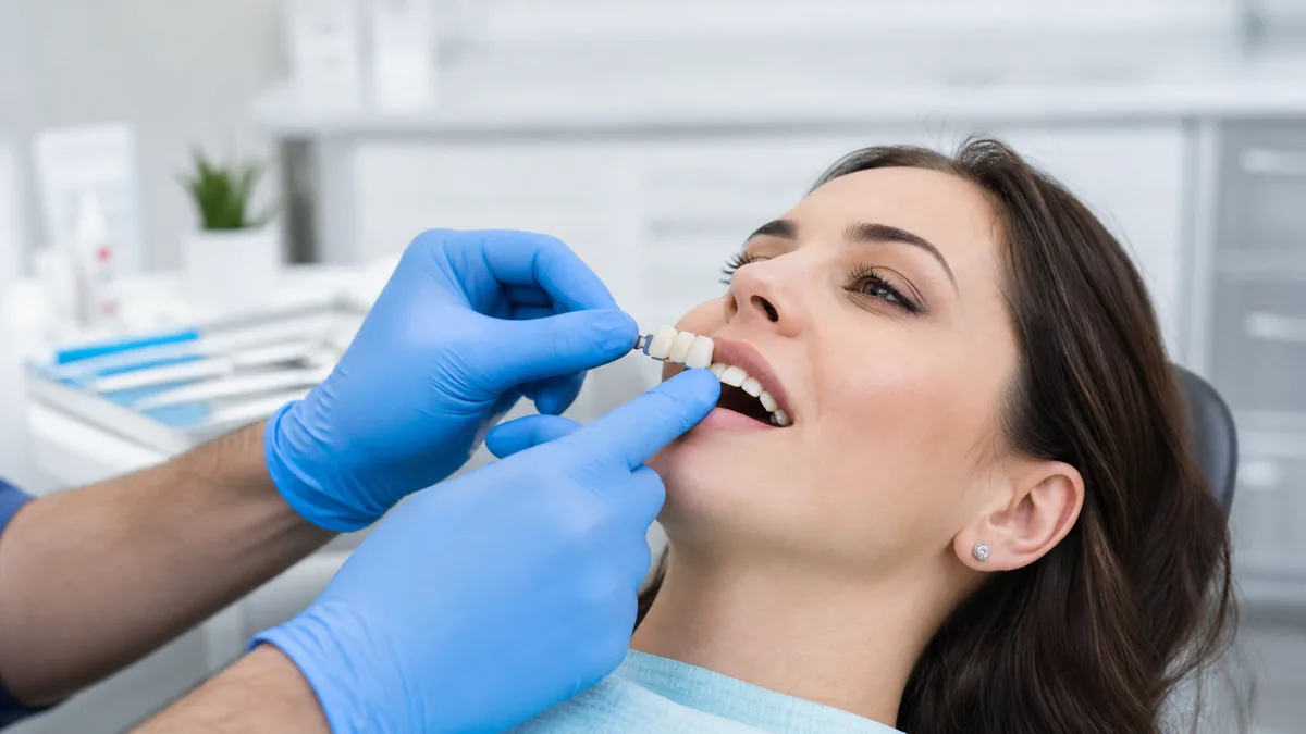 Dentist carefully placing a custom porcelain dental bridge at Sunrays Smiles Dental Care clinic in Winter Springs, Florida